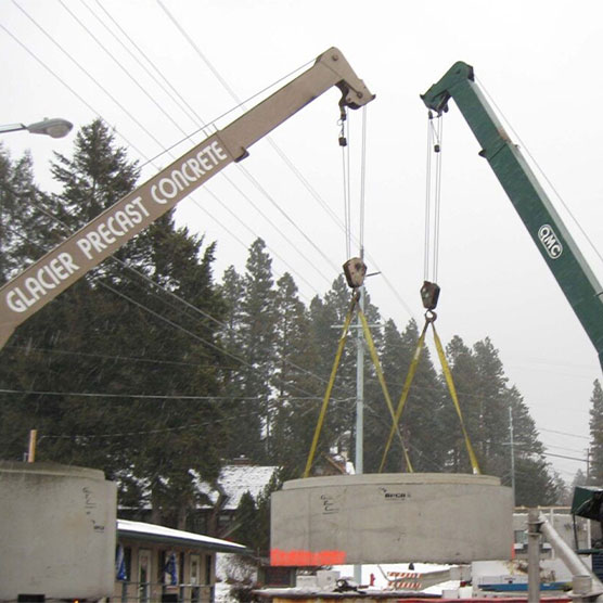 Two cranes moving a precast structure
